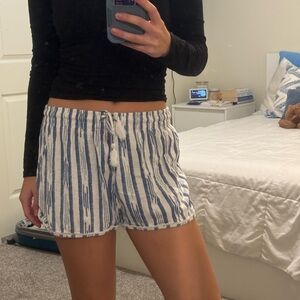 small flowy blue and white stripped shorts with a tassel drawstring